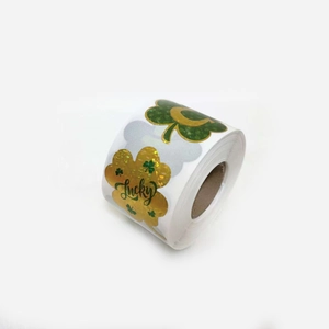 Macro detail of holographic lucky four-leaf clover stickers for gift packaging rolls