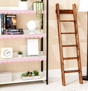 Pink and white gingham scalloped border trim applied to a wooden bookshelf detail