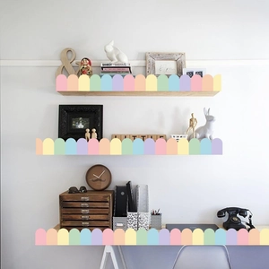 Detail of colorful scallop bulletin board borders applied to wooden shelves and furniture