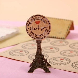 Round kraft thank you stickers with red hearts on Eiffel Tower metal display stand