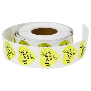 Roll of heart shaped thank you stickers in fluorescent yellow for gift packaging labels