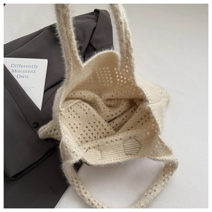 Close-up of cream knit tote bag showing plush mohair texture and openwork crochet patterns