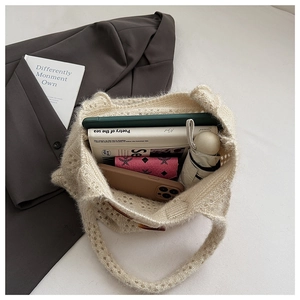 Detail view of large capacity cream knit tote bag showing interior storage and texture