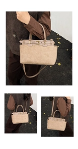 Detail view of suede patchwork handbag showing top handle and adjustable shoulder strap