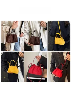Detail view of ruched cloud bags in dark brown, mustard yellow, and vibrant red