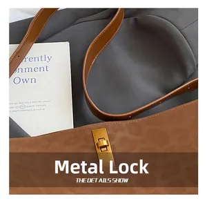 Detailed close-up of premium gold metal clasp and leather strap on leopard print tote
