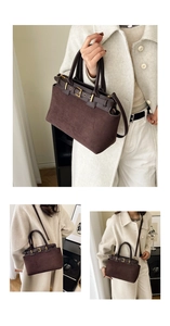 Detail of dark brown suede handbag with decorative leather straps and gold buckle accents