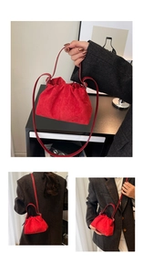 Detail of red suede cloud bag with pleated texture and versatile carrying straps