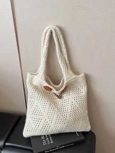 Chic beige cable knit tote bag with hollow crochet design and brown horn button closure