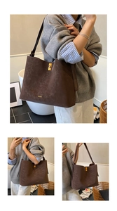 Detail of dark brown suede tote bag with golden twist lock and logo on front