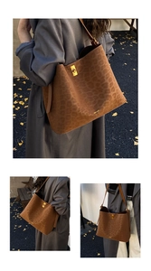 Detail of leopard print suede tote bag featuring a gold twist-lock and brand logo