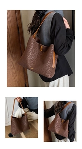 Detail of leopard print suede tote bag with leather strap and golden metallic buckle