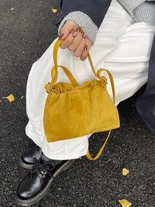 Fashionable ginger yellow suede cloud bag with drawstring and crossbody strap