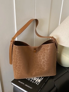 Brown leopard print suede tote bag with gold lock buckle on design books