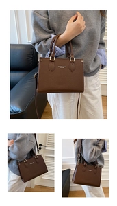 Detail of dark brown lychee textured tote bag with top handle and adjustable strap