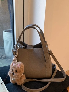 Retro khaki lychee pattern leather bucket bag with top handles and plush dog charm