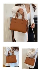 Close-up of brown pebbled leather texture and gold hardware on a minimalist handbag