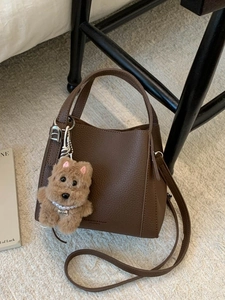 Retro dark brown litchi leather bucket bag with puppy charm and pearl detail