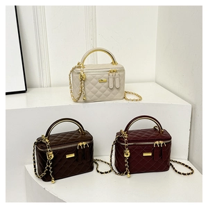 Detailed view of quilted leather mini bags in beige brown and burgundy with gold handles