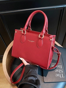 Elegant red lychee grain leather tote bag with gold hardware and a detachable shoulder strap