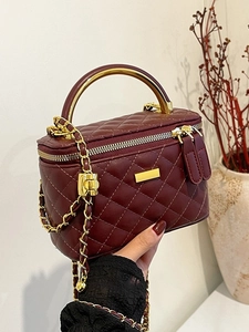 Burgundy quilted chain crossbody bag with gold handle and metal plate detail