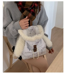 Detail of the faux fur rabbit ear backpack featuring blue pattern and drawstrings