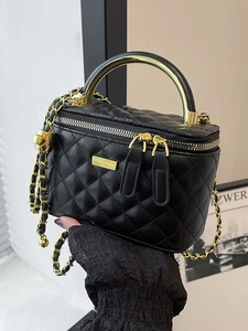 Quilted black chain crossbody bag with golden metal handle and refined leather texture