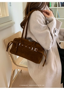Retro dark brown suede underarm bag shown in a minimalist sophisticated lifestyle setting