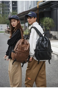 Outdoor street view of dark brown and black leather backpacks for students and travel