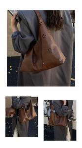 Detailed view of dark brown hollowed-out leather tote bag with floral laser-cut patterns