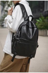 Macro shot of high-quality black PU leather texture and durable zippers on this backpack