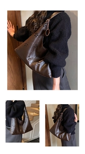Close-up of laser-cut floral patterns on dark coffee leather hobo shoulder bag