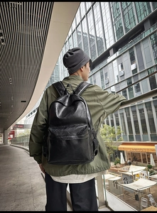 Close-up of the large capacity black leather backpack showing the premium PU texture