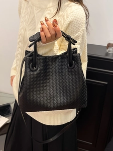 Classic black woven leather handbag with double handles and long shoulder strap