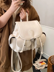 Creamy white pleated crossbody backpack with multiple pockets and drawstring flap closure