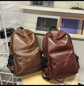 Detail of vintage PU leather backpack featuring side mesh pockets with buckle straps