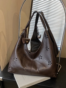 Brown laser-cut hollow tote bag for women with floral patterns and a round pendant