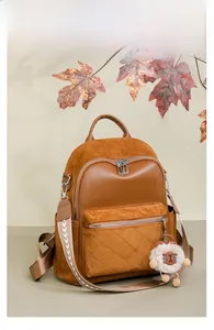 Brown retro patchwork backpack featuring diamond stitching and cute sheep pendant detail