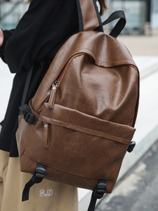 Vintage brown leather backpack with multiple zippers and adjustable straps for daily travel