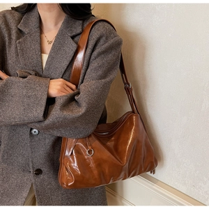 Side view of caramel brown vintage oil wax leather tote bag with adjustable strap