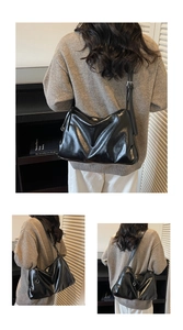 Detail view of the sleek black large capacity crossbody bag with shiny finish