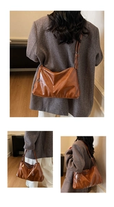 Detail view of large caramel vintage tote showing soft oil wax leather texture and metal rings