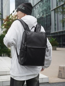 Minimalist black PU leather backpack for men used for business travel and commuting