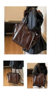 Detail view of large dark brown retro tote bag with vertical stitching and side drawstrings