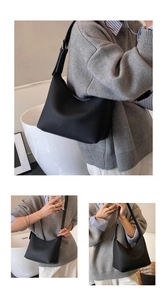 Detail of black pebbled leather hobo bag showing adjustable strap and large capacity