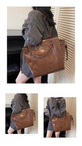 Detail view of large brown vintage tote bag with drawstring sides and leather texture
