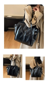 Close-up of black tote bag featuring glossy textured faux leather and drawstring details