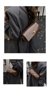 Detail of dark brown glossy leather shoulder bag with golden oval twist lock and chain strap
