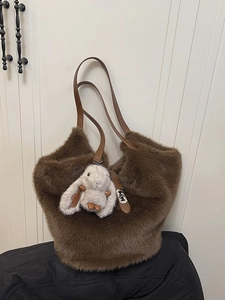 Large brown plush faux fur tote bag with leather handles and white rabbit charm