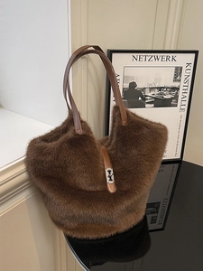 Large dark brown plush tote bag with metal twist lock and leather handles for autumn